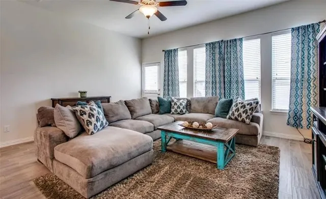 a living room with furniture and a large window