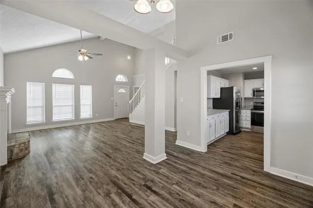 a view of a kitchen with wooden floor and a kitchen