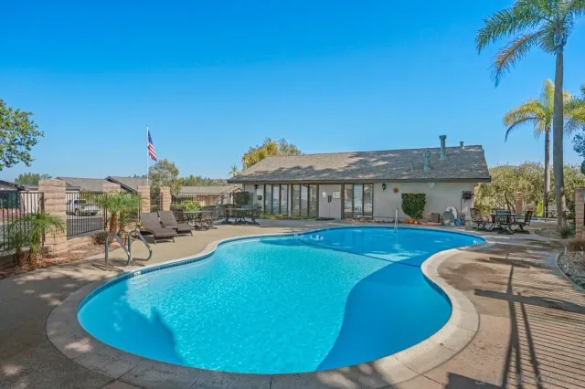 a view of a patio with a table and chairs