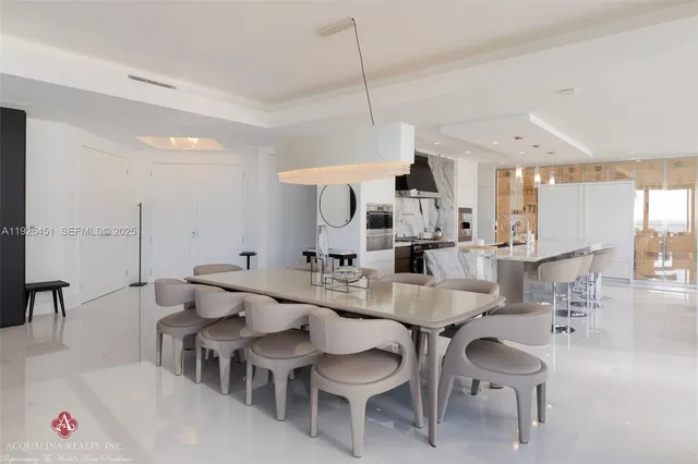 a kitchen with stainless steel appliances kitchen island granite countertop a sink and cabinets