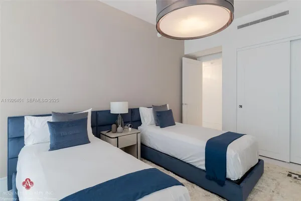 a bedroom with furniture and a large window