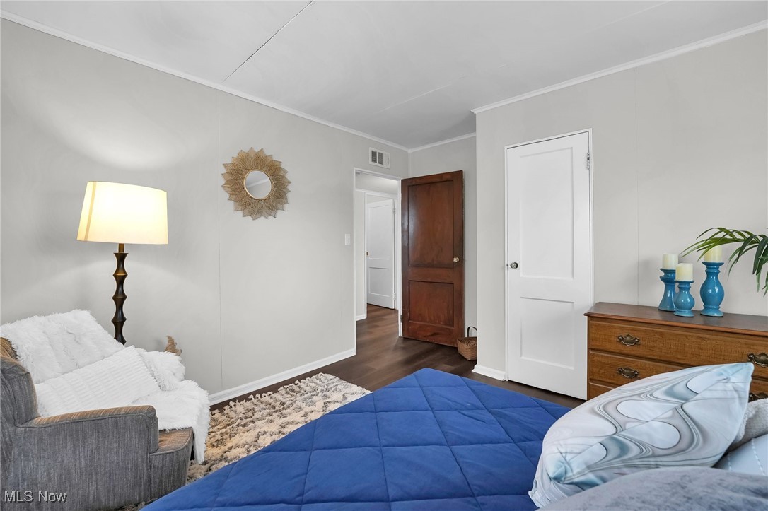 156 South Hampton Road Columbus, OH 43213 - Photo 19 of 25 Bedroom featuring ornamental molding, dark wood finished floors, visible vents, and baseboards