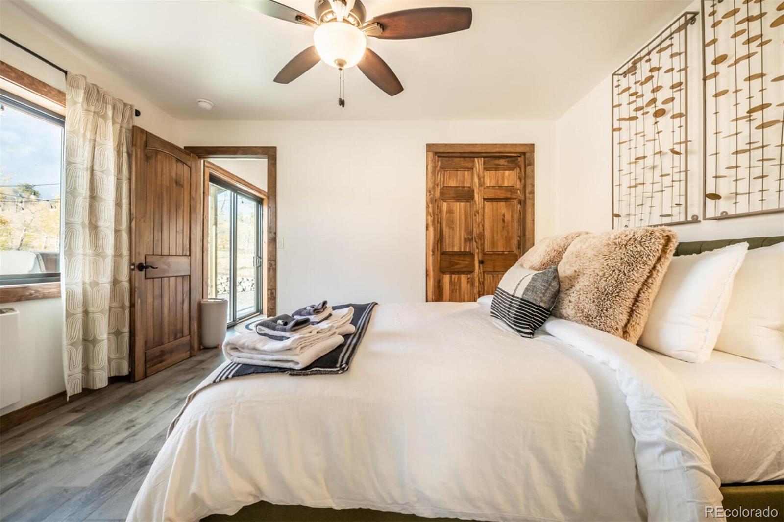 203 High Creek Road Fairplay, CO 80440 - Photo 12 of 30 a bedroom with a bed and wooden floor