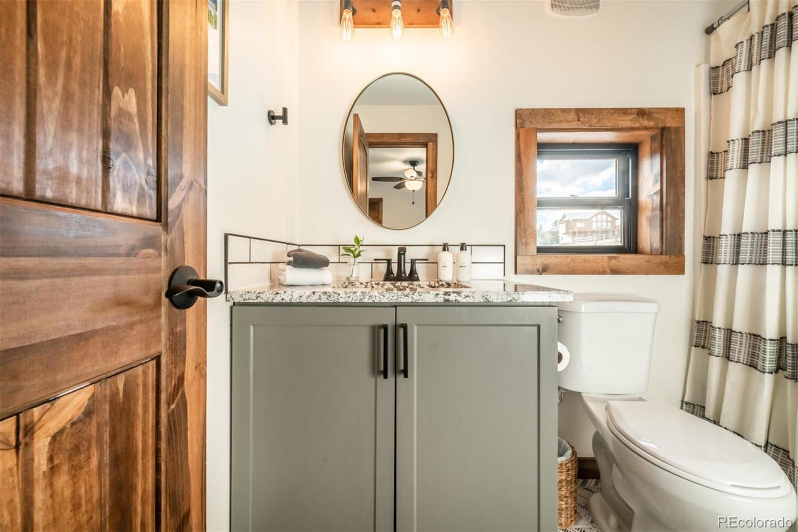 203 High Creek Road Fairplay, CO 80440 - Photo 13 of 30 a bathroom with a toilet a sink and a mirror
