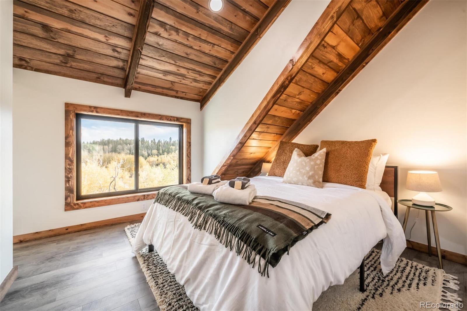 203 High Creek Road Fairplay, CO 80440 - Photo 15 of 30 a bed sitting in a bedroom next to a window