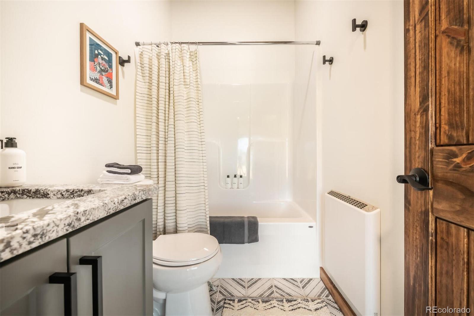 203 High Creek Road Fairplay, CO 80440 - Photo 16 of 30 a bathroom with a granite countertop sink toilet and shower