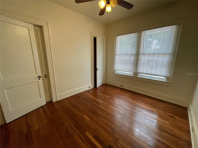 wooden floor in an empty room with a window