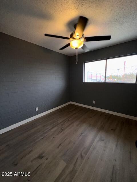 2551 West Berridge Lane, Unit D6 Phoenix, AZ 85017 - Photo 11 of 20 a view of an empty room with wooden floor and a window