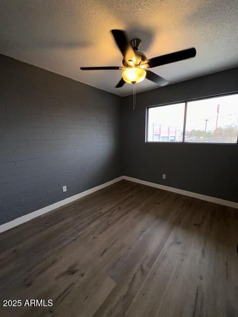 2551 West Berridge Lane, Unit D6 Phoenix, AZ 85017 - Photo 12 of 20 a view of an empty room with wooden floor and a window