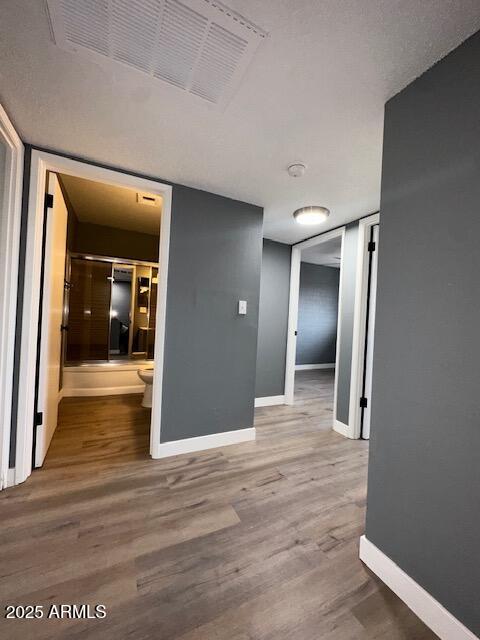 2551 West Berridge Lane, Unit D6 Phoenix, AZ 85017 - Photo 16 of 20 a view of a hallway with wooden floor