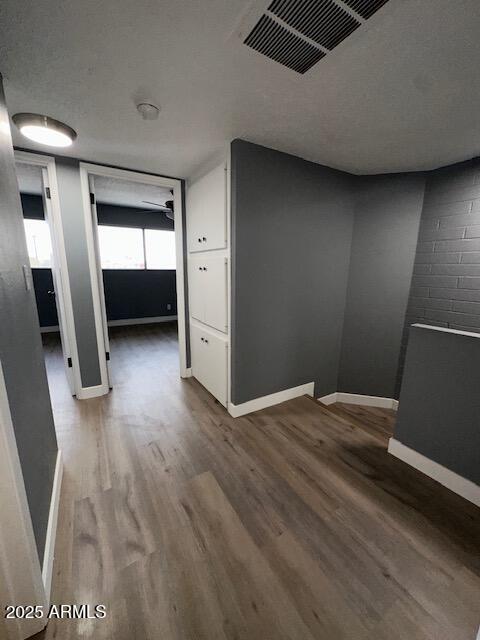 2551 West Berridge Lane, Unit D6 Phoenix, AZ 85017 - Photo 17 of 20 a view of empty room with wooden floor and window
