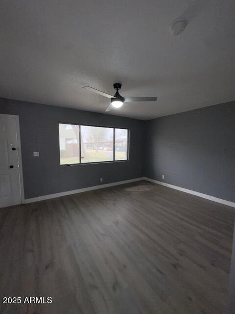 2551 West Berridge Lane, Unit D6 Phoenix, AZ 85017 - Photo 6 of 20 an empty room with wooden floor and windows