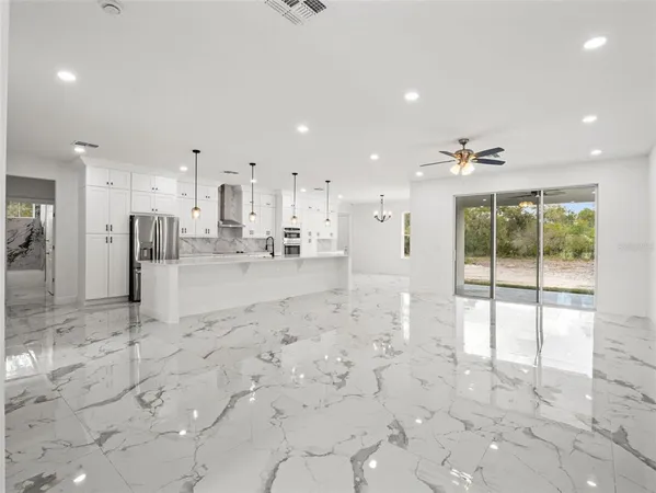 a view of kitchen with stainless steel appliances sink refrigerator and cabinets