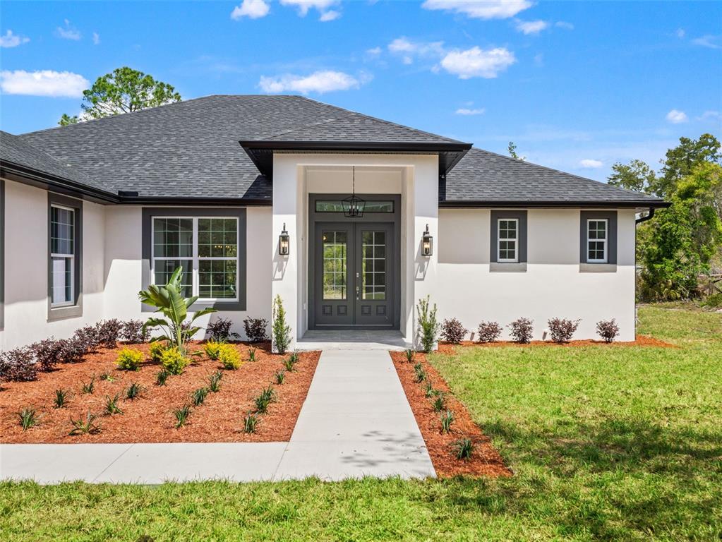 42430 Fir Street Eustis, FL 32736 - Photo 2 of 44 a front view of a house with a yard