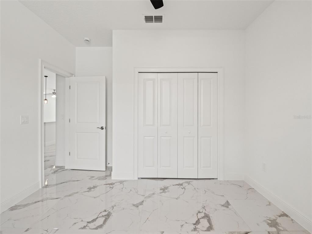 42430 Fir Street Eustis, FL 32736 - Photo 22 of 44 an empty room with cabinet door