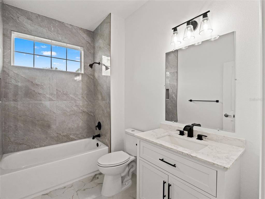 42430 Fir Street Eustis, FL 32736 - Photo 24 of 44 a bathroom with a sink a toilet and shower