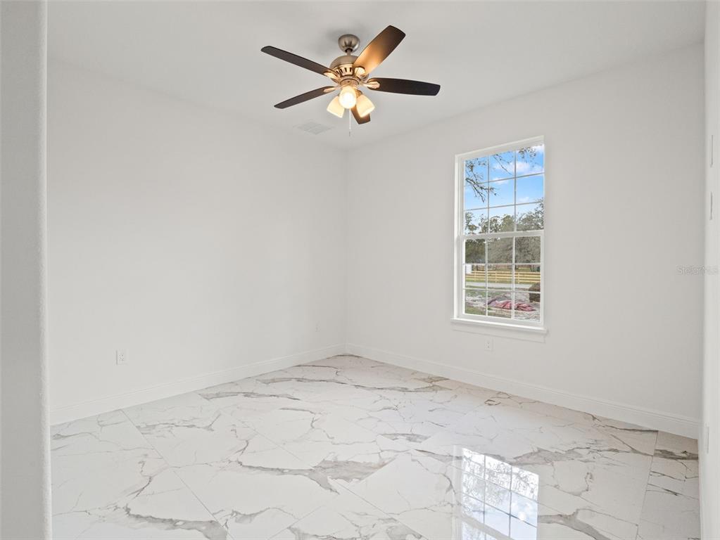 42430 Fir Street Eustis, FL 32736 - Photo 26 of 44 an empty room with a window and a fan