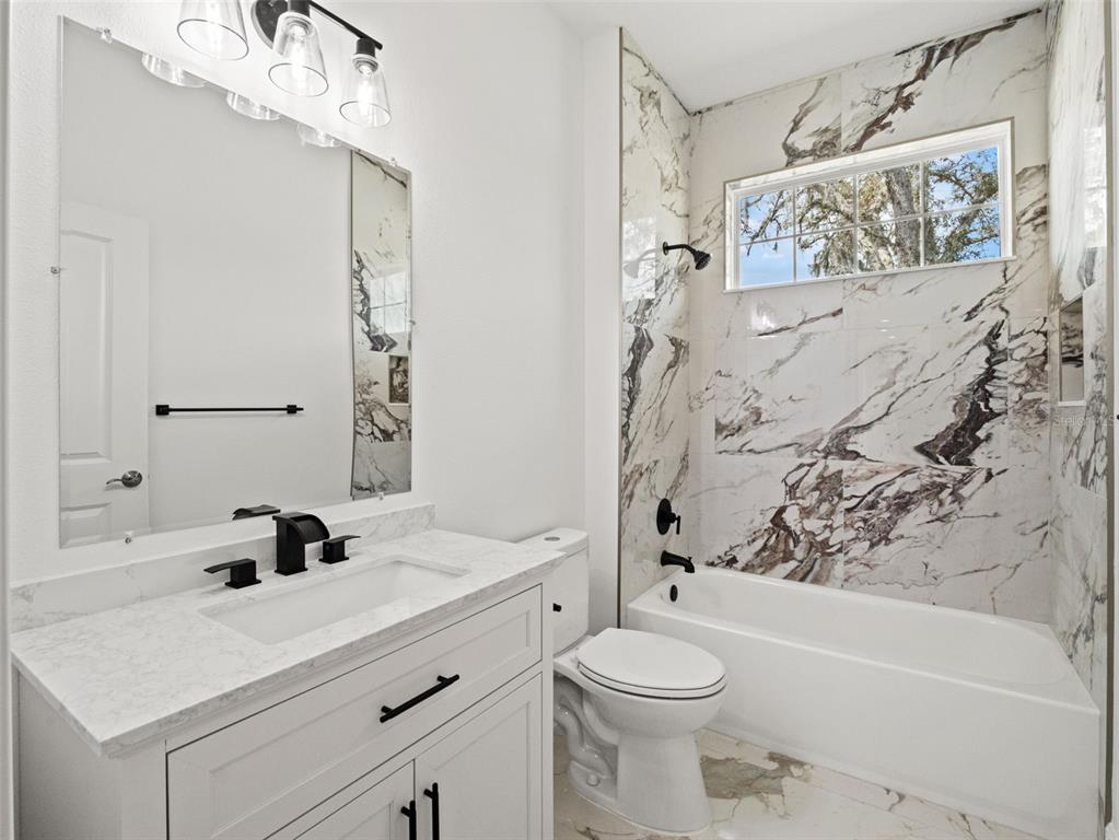 42430 Fir Street Eustis, FL 32736 - Photo 27 of 44 a bathroom with a sink a toilet and shower