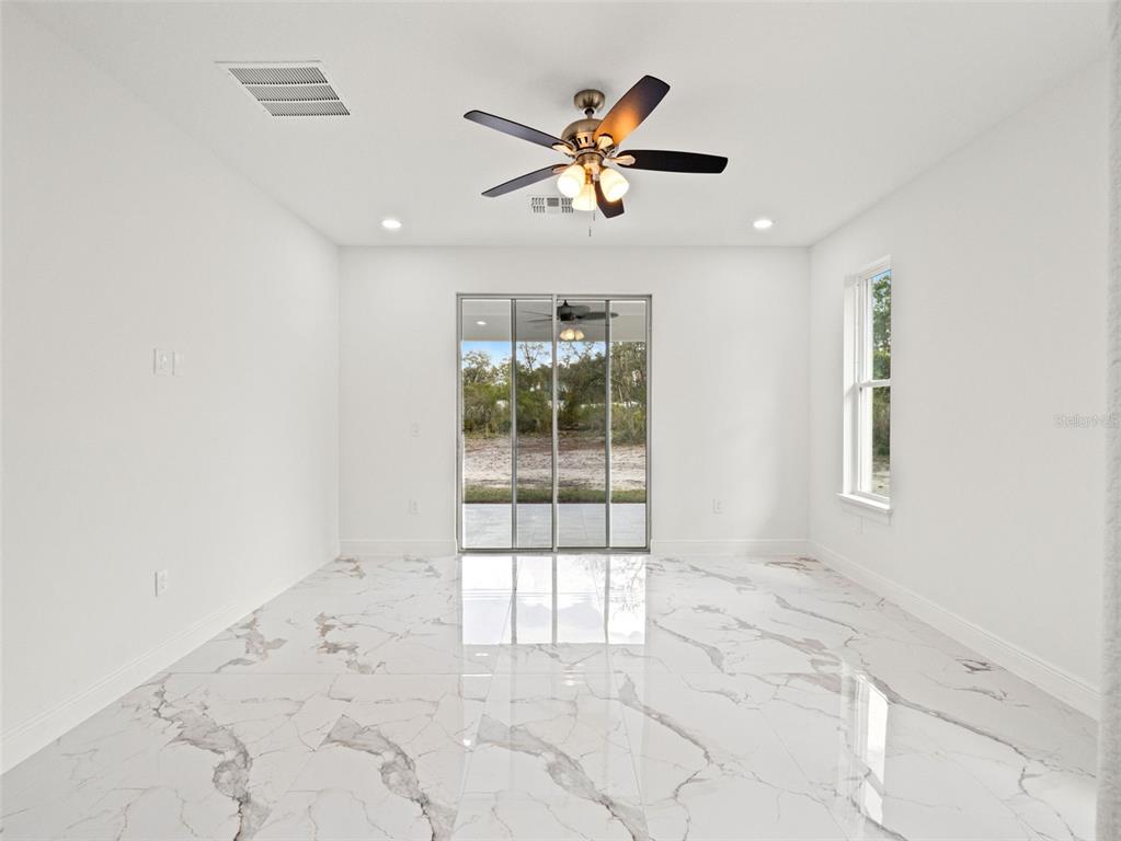 42430 Fir Street Eustis, FL 32736 - Photo 29 of 44 a view of a livingroom with a ceiling fan and window