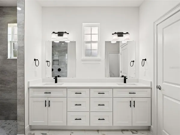 a view of a kitchen with white cabinets