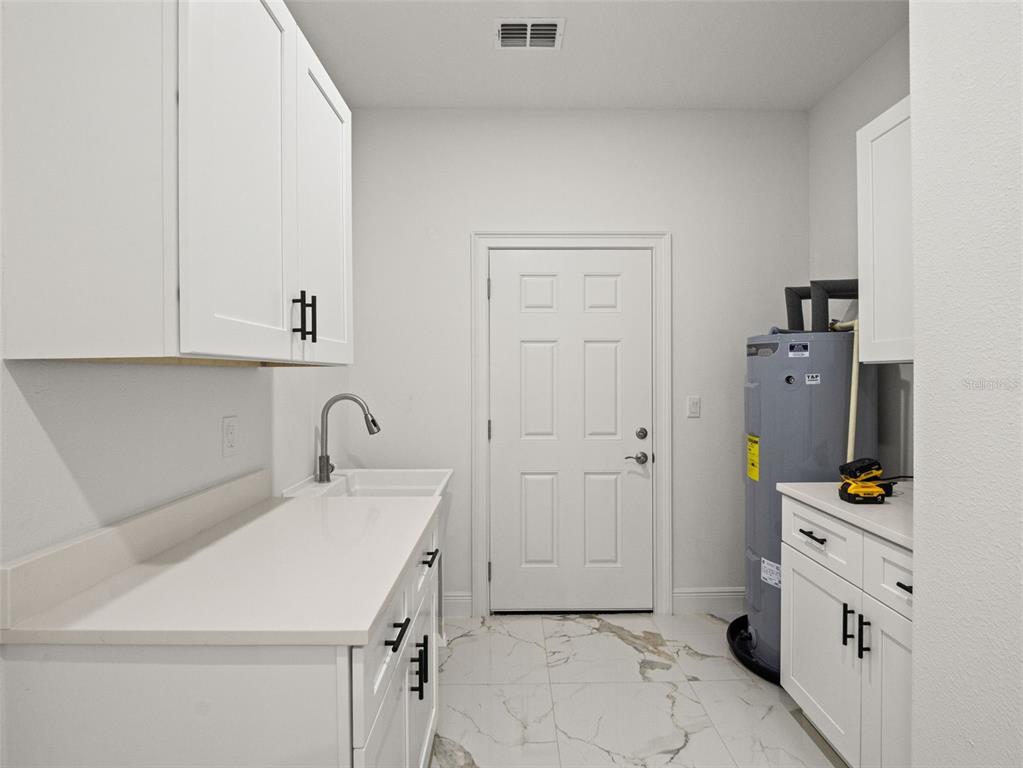 42430 Fir Street Eustis, FL 32736 - Photo 36 of 44 a view of a kitchen with white cabinets