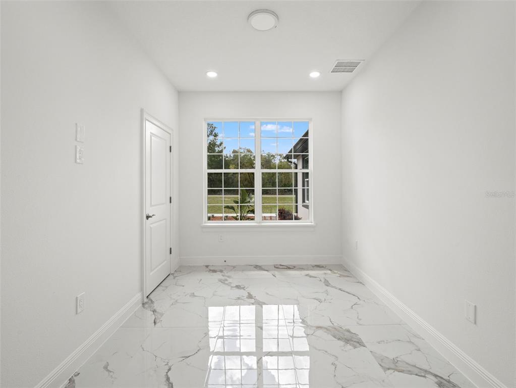 42430 Fir Street Eustis, FL 32736 - Photo 6 of 44 an empty room with a window