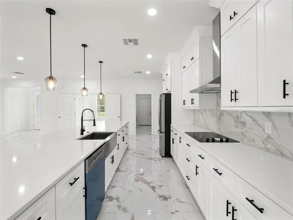 a kitchen with stainless steel appliances a sink a counter space and a window
