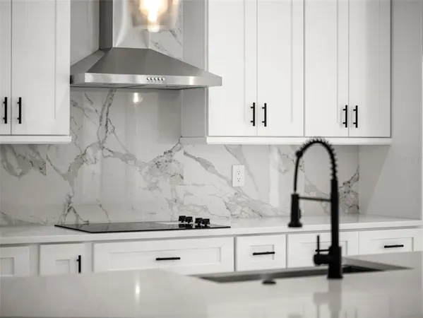 a close view of kitchen sink with granite countertop