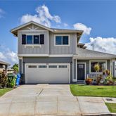 a front view of a house with a garden and plants