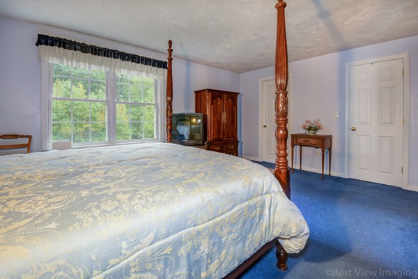 5 Garrison Road Shirley, MA 01464 - Photo 12 of 29 a large bed sitting in a bedroom next to a window