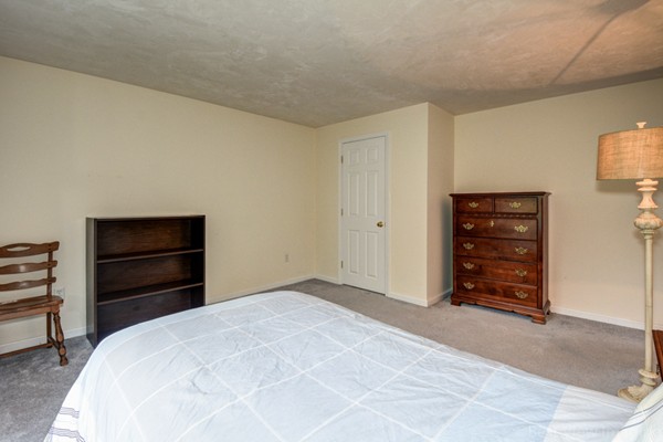 5 Garrison Road Shirley, MA 01464 - Photo 16 of 29 a room with a dresser and a chair