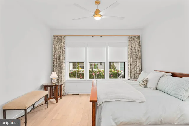 a spacious bedroom with a bed and a window