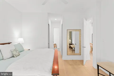 a bedroom with a large bed and a chandelier