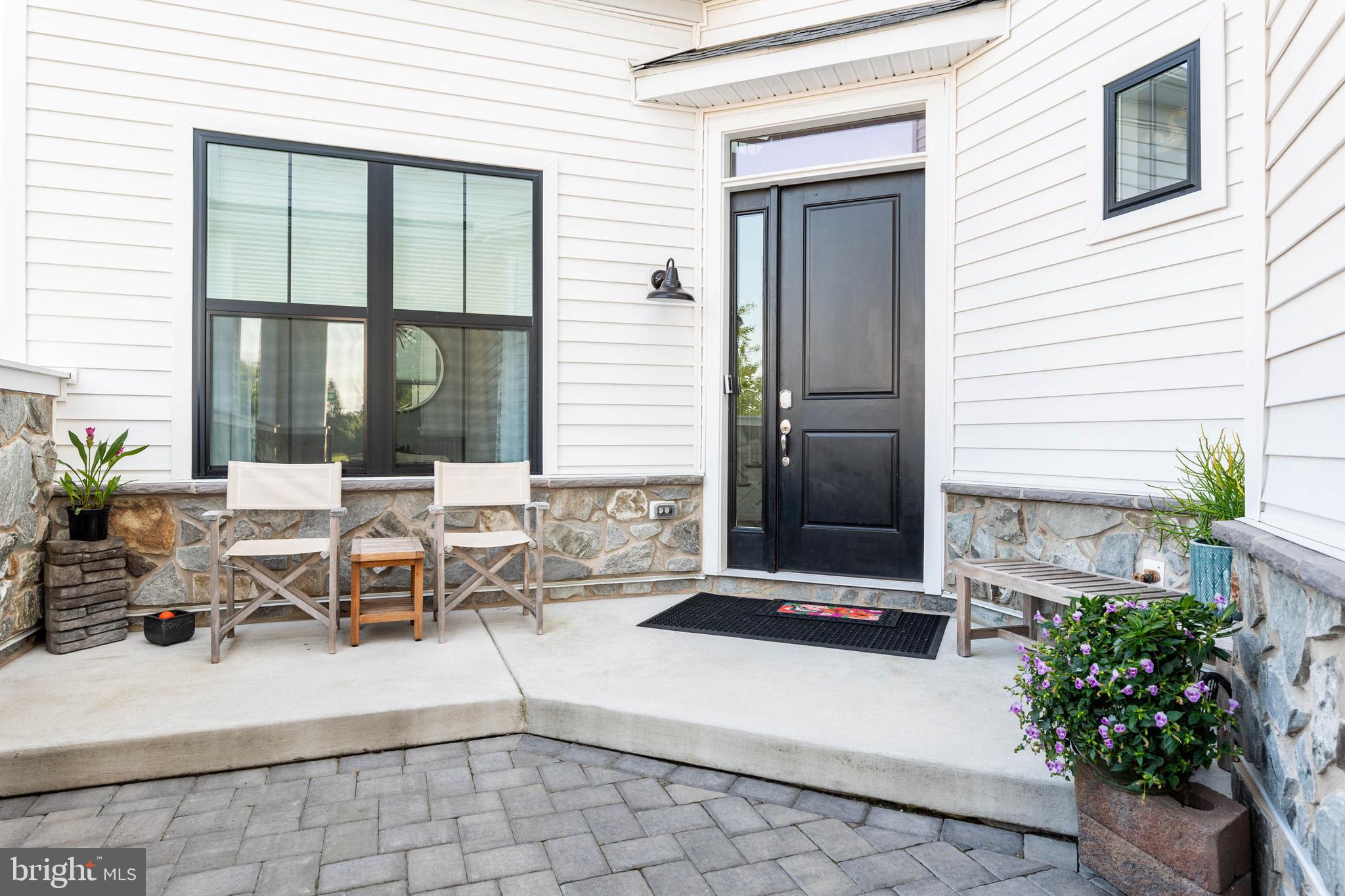 142 Preakness Way Downingtown, PA 19335 - Photo 2 of 56 a living room with patio furniture and potted plants