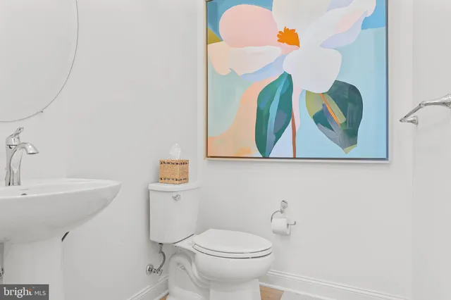 a bathroom with a granite countertop sink a toilet and a shower curtain