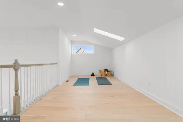 a living room with furniture a window and a lamp