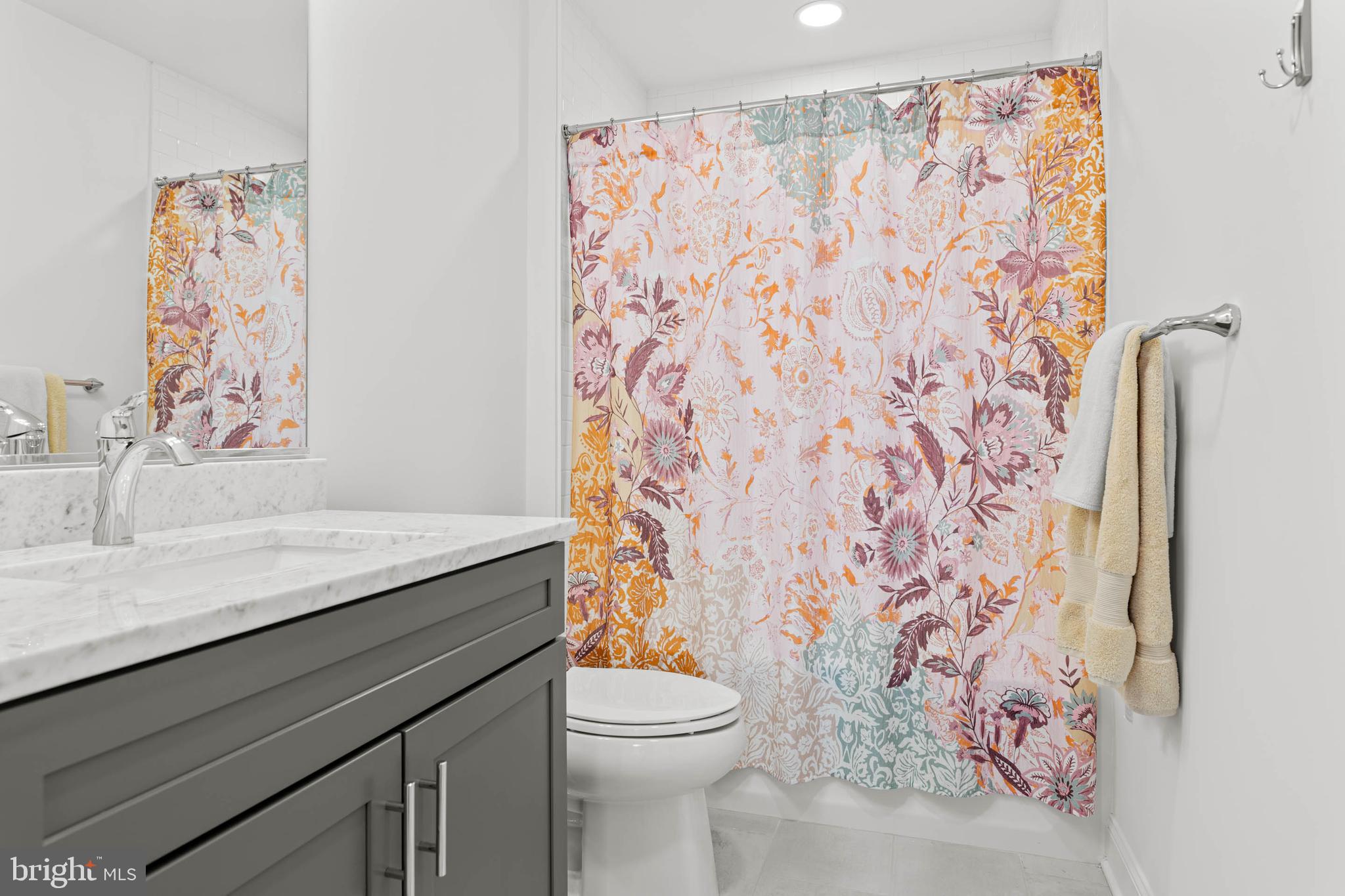142 Preakness Way Downingtown, PA 19335 - Photo 33 of 56 a bathroom with a granite countertop sink a toilet and a shower curtain