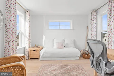 a balcony with potted plants and a bench