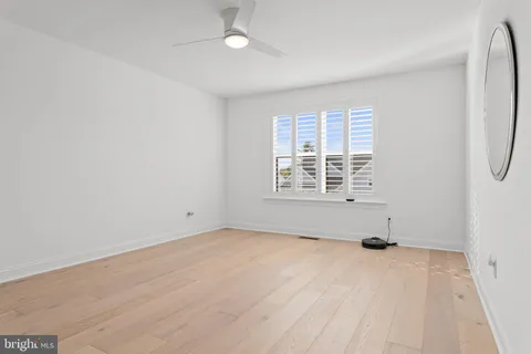 a view of an empty room with a window and a couch