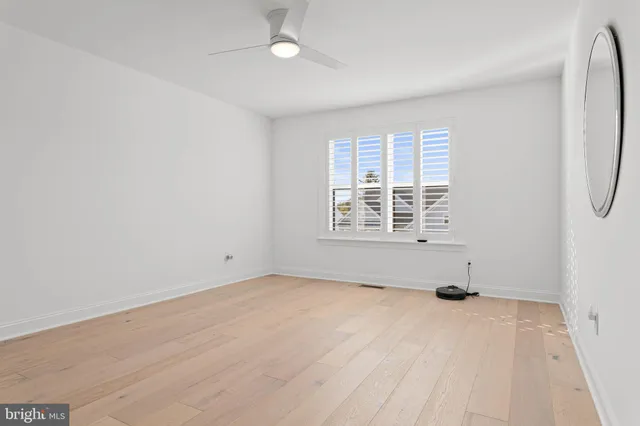 a view of an empty room with a window and a couch