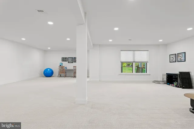 a front view of a house with a yard and trees