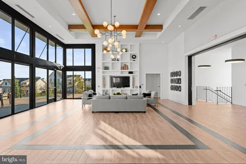 a dining room with furniture a chandelier and wooden floor