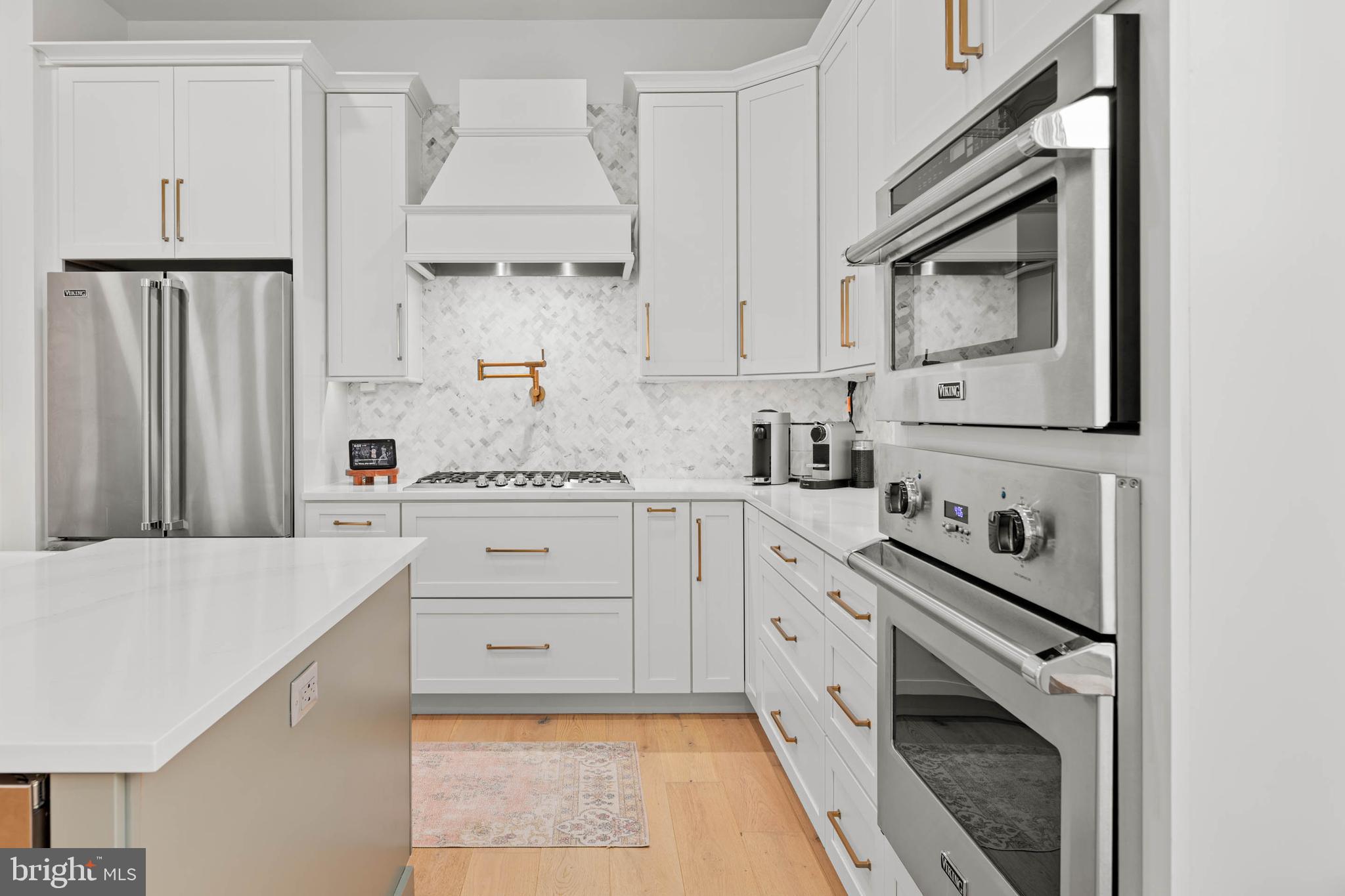 142 Preakness Way Downingtown, PA 19335 - Photo 9 of 56 a kitchen with white cabinets stainless steel appliances and sink