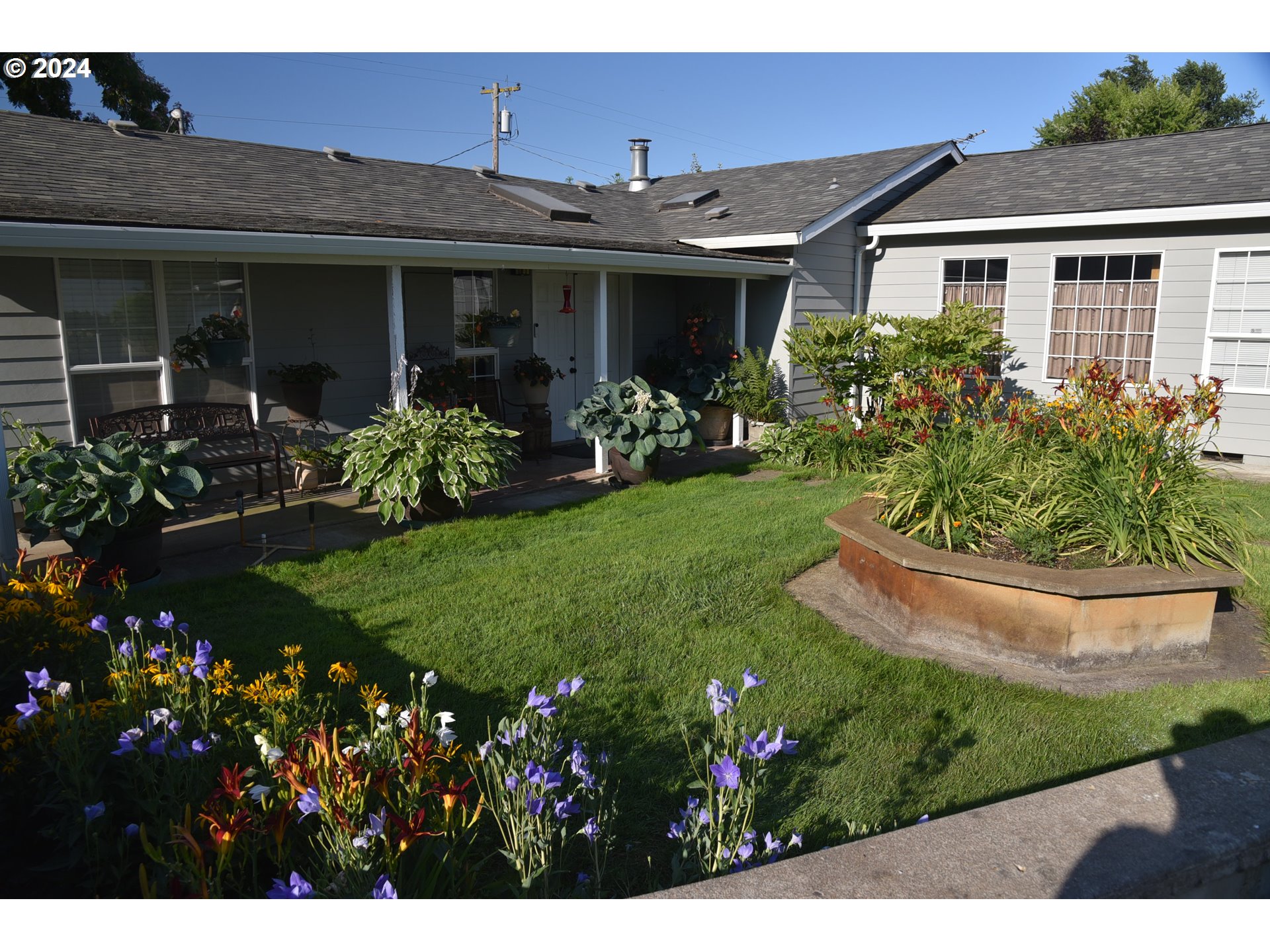 a view of a house with garden and porch