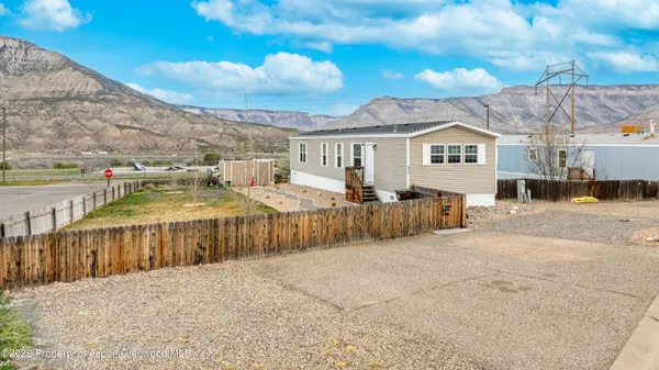 a view of a house with wooden fence