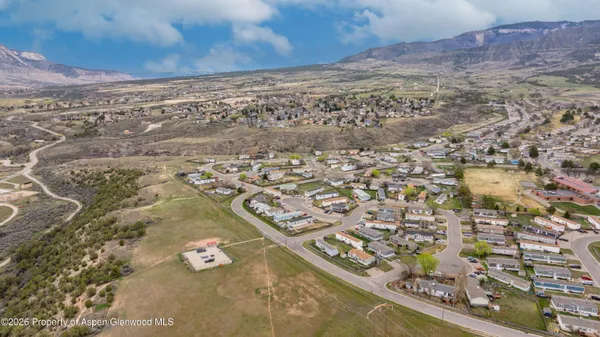 an aerial view of residential houses with outdoor space