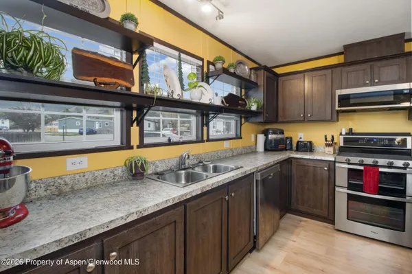 a kitchen with stainless steel appliances granite countertop a sink and a counter