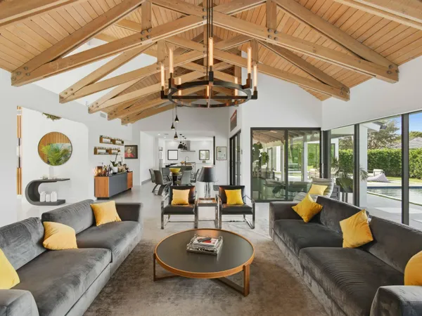 a living room with furniture and a chandelier