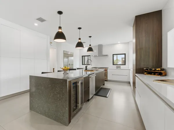 a kitchen with stainless steel appliances a stove a sink and a refrigerator