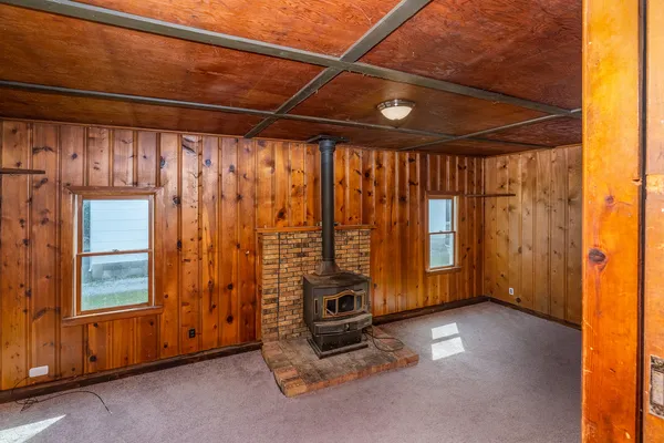a view of a room with wooden floor and windows